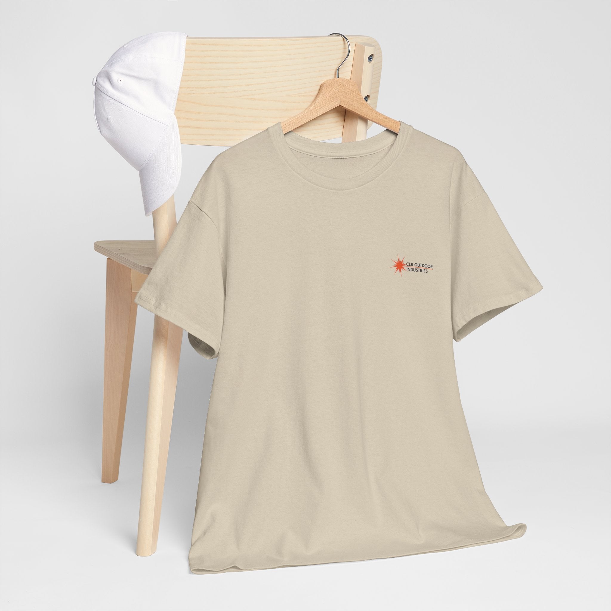 „Sandfarbenes NEW WAVE CLR Outdoor Industrie T-Shirt von CLR Outdoor GmbH mit kleinem roten Stern-Kompass-Logo und Schriftzug CLR Outdoor Industries auf der linken Brust.hängend mit Kleiderbügel am Stuhl präsentiert."